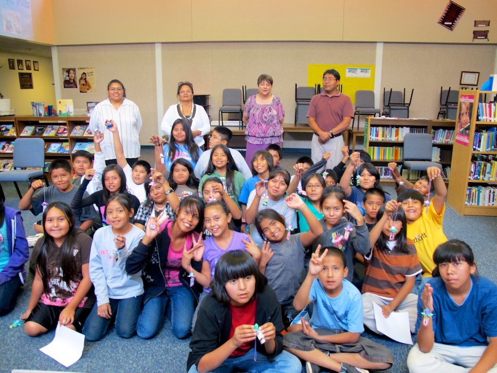 Navajo schoolchildren hold up their lotus flowers